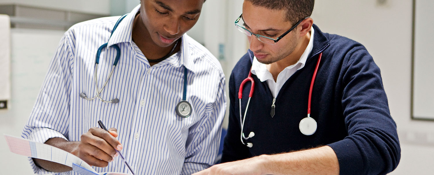 Two Queen Mary Medical students compare notes
