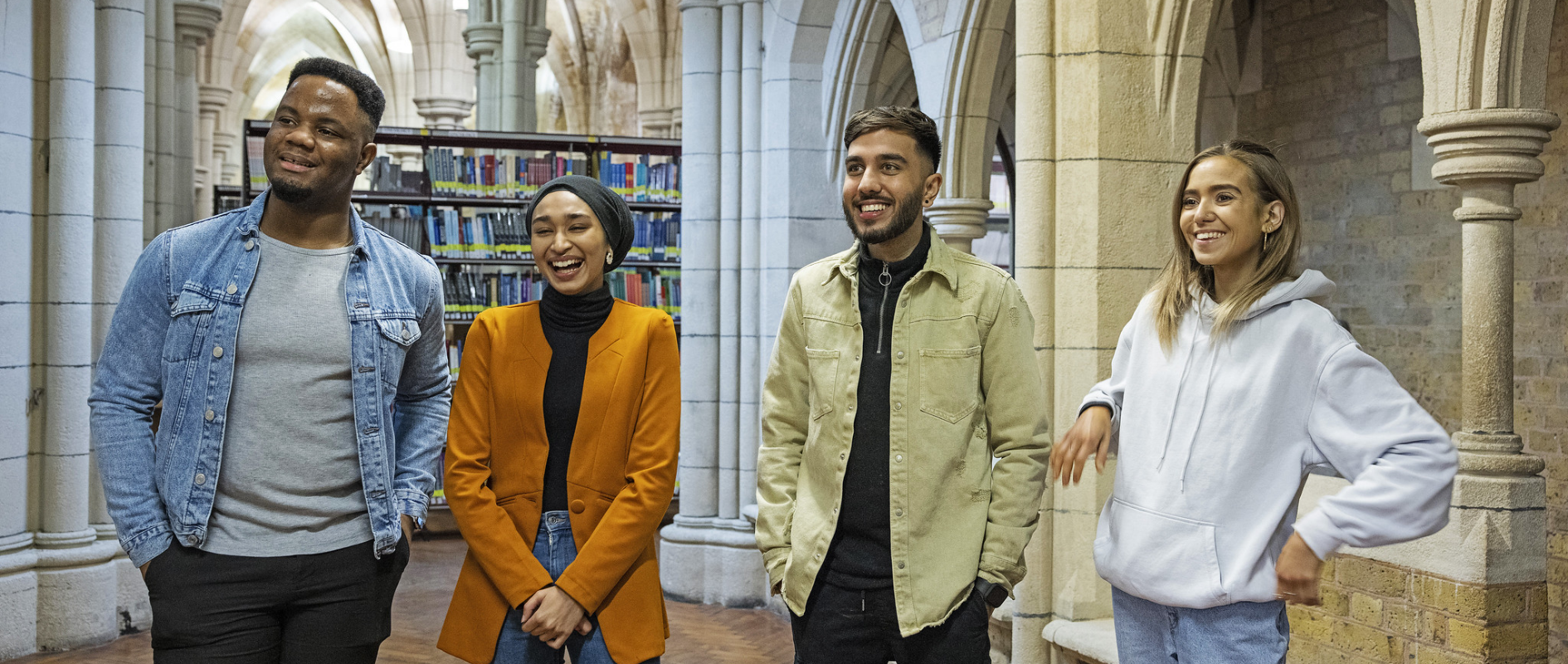 Shot of four students inside a library