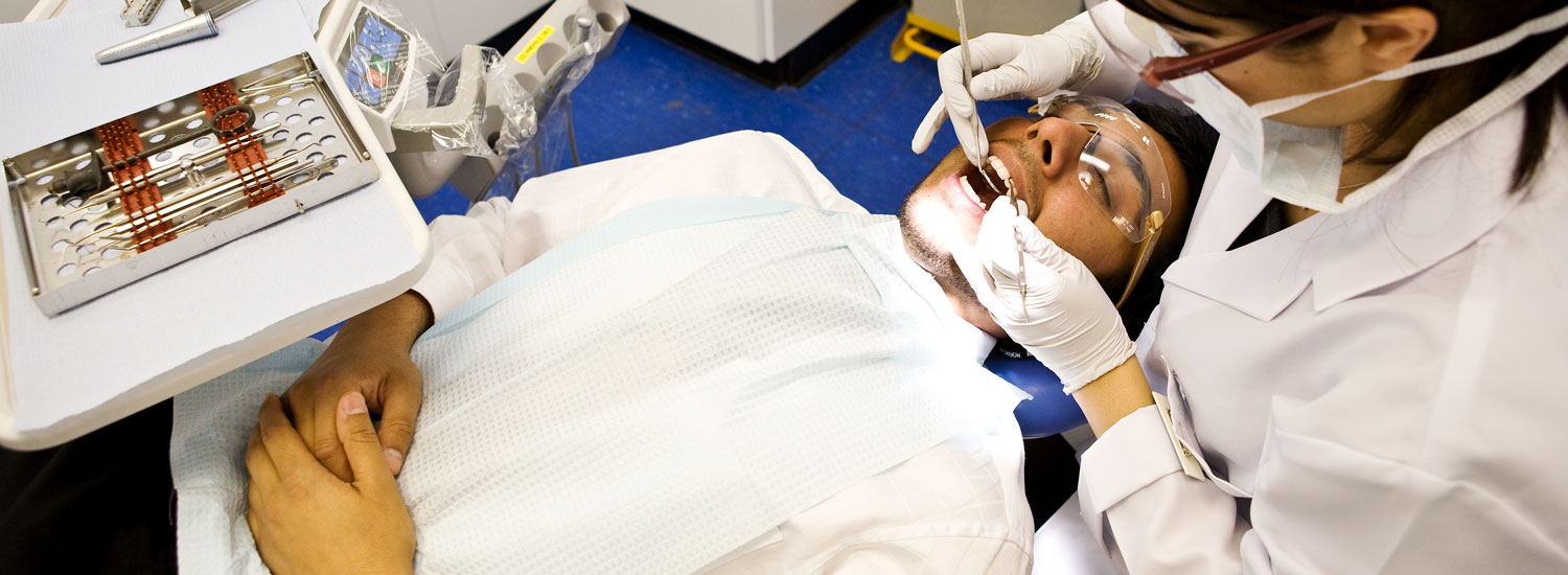 A dental student working on a patient