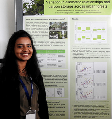 Environmental science student Mishma Abraham presenting a poster on the importance of urban forests.  