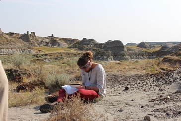 Zoology student Jordan works on his field notebook in the spectacular Dinosaur Provincial Park.