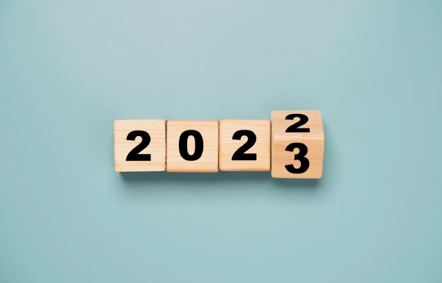 Wooden blocks reading '2022' with the final block turning to '3' to represent 2023