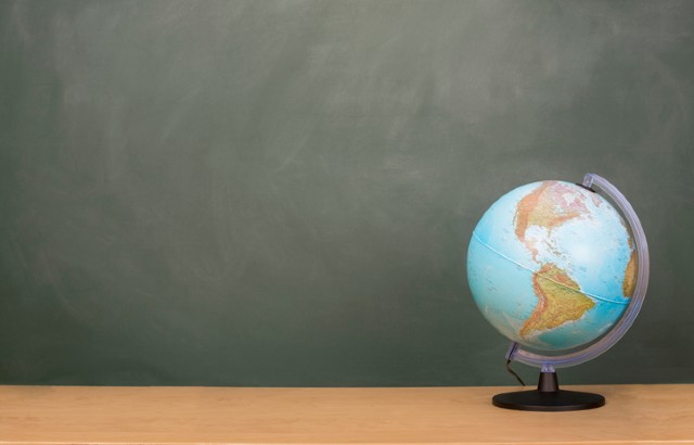 The planetary rarely lands on the desk of the local or national policymaker, says Professor Colin Grant. Image: A small globe sits on a wooden desk with a blackboard in the background.