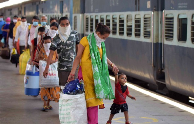 Migrants from Mumbai arrive by a special train at Prayagraj Junction during a national coronavirus lockdown in May 2020