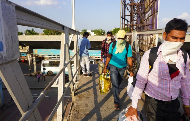 Indian migrant workers return home at a railway station during the national coronavirus lockdown