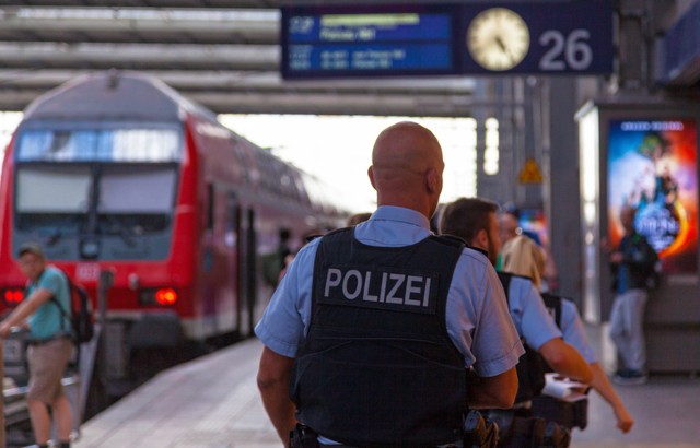 Police officers in bulletproof vests patrol Munich's main railway station.
