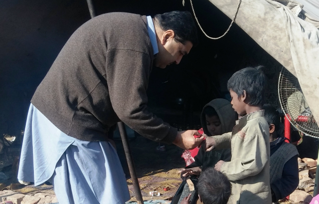 A doctor attends to a child in Pakistan
