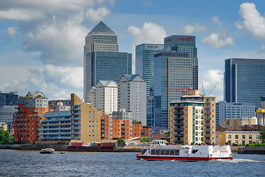 View of skyscrapers of Canary Warf from the river Thames