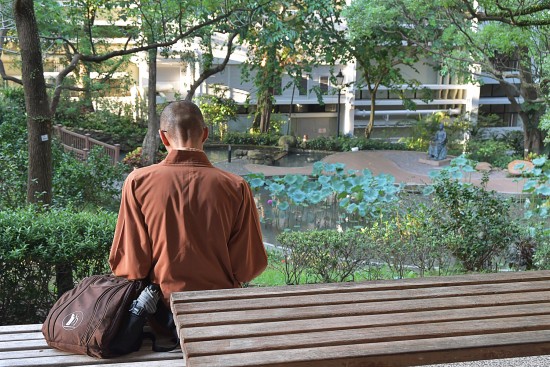 Picture of a student sitting on a bench in Hong Kong