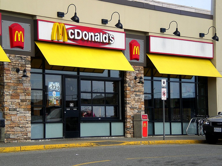 A McDonald's shopfront with colourful yellow awning