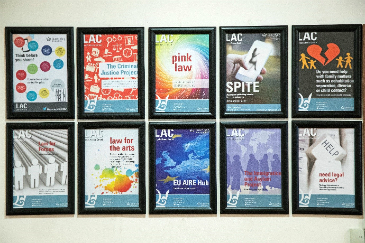 Five framed posters on a wall showing the Legal Advice Centre's different Community Projects.