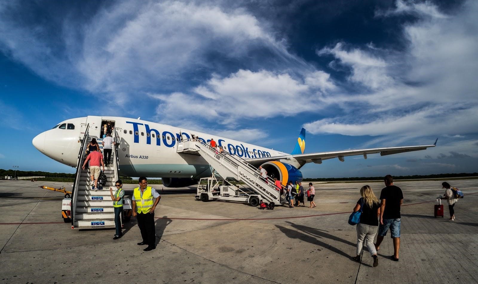 People board a Thomas Cook aeroplane from the tarmac at Jardines del Rey Airport, Cayo Coco, Cuba. IMG: CWhatPhotos