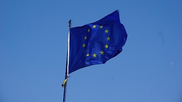 EU Flag blowing in the wind against a blue sky