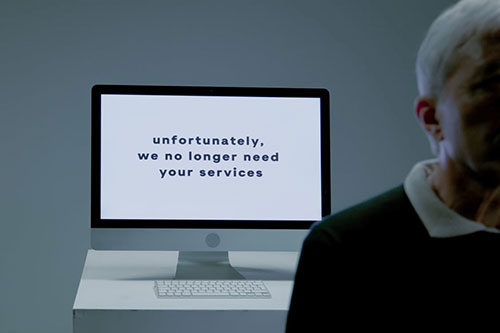 A computer screen displaying a message saying 'we no longer need your services'