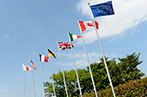 G7 flags on poles. Left to right: Japan, USA, France, Germany, UK, Italy, Canada and EU