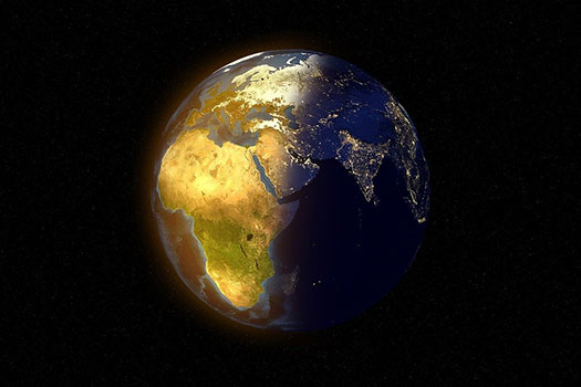 Image of a globe with Africa in daylight and Asia in night on a black background