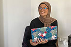 Assia Al Jerrari holding a laptop