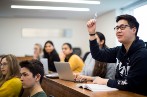 queen mary law student raising a hand in a lecture