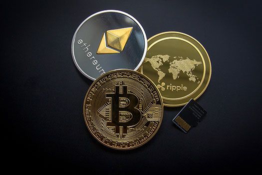 Bitcoin, Ethereum and Ripple logos on coins