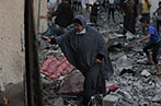 A woman walking among rubble in Gaza