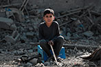 A child sat amongst rubble in Gaza