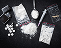 Various recreational drugs laid out on a black background