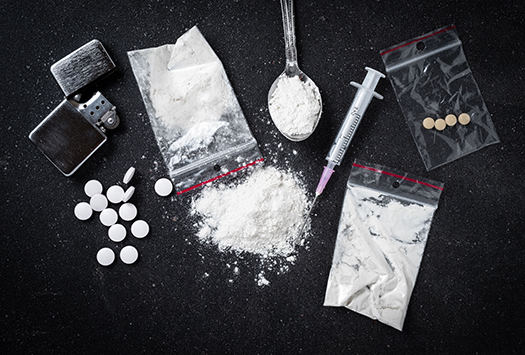 Various examples of recreational drugs on a black background