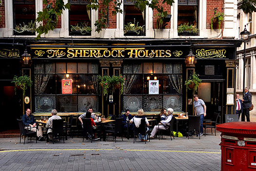 People sitting outside the Sherlock Pub in London