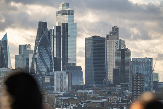 Skyline of Bank, London against a cloudy sky.