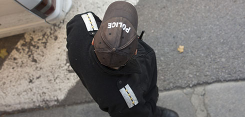 Overhead shot of Police officer in uniform on pavement