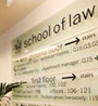 Directional signs in the foyer of the Law Building at Queen Mary