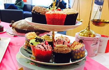 Various cupcakes on a cake stand at the LAC Legal Bake Sale