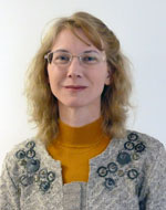 A profile picture of Professor Rachael Mulheron. She has curly blonde hair and wears glasses.