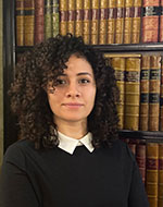 Merna Nasralla standing in front of books