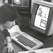 Black and white image of a person sitting in front of a computer