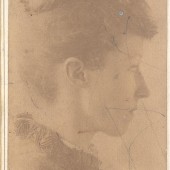 Sepia photograph of a woman in profile clothed in late 19th century dress