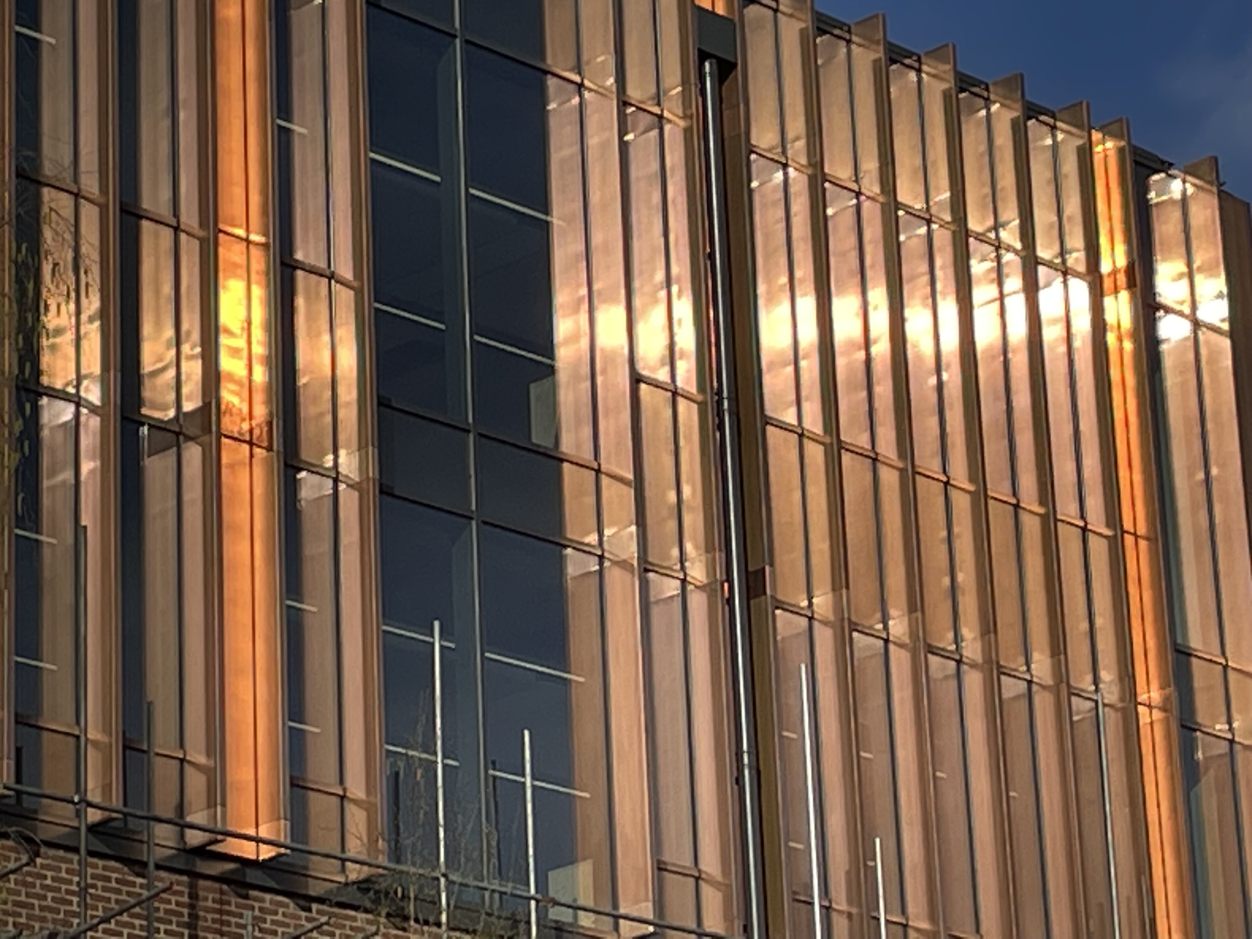 Exterior building showing light bouncing off copper cladding