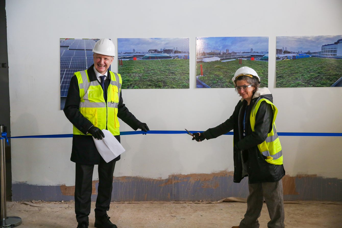 Principal Professor Colin Bailey and University Librarian Kate Price cutting the ribbon as part of the topping out ceremony