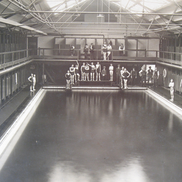 Photograph of Swimming pool with boys in bathing suits at the edge
