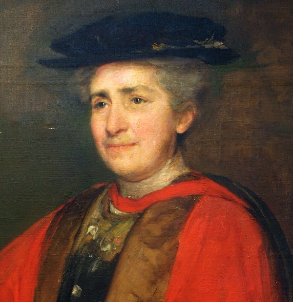 Colour photograph of a painting of Caroline Skeel in about 1920.  She is dressed in red academic robes with brown trim and a black doctoral hat (tudor bonnet)