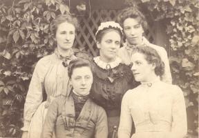 Formal photograph of five standing and seated Westfield College Staff in a garden