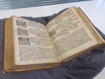 Photograph of the A mahzor (book of liturgical prayers) for the feasts of Sukot, Pesach and Shavu’ot, dating from 1784; the book is open and sitting on a book cushion