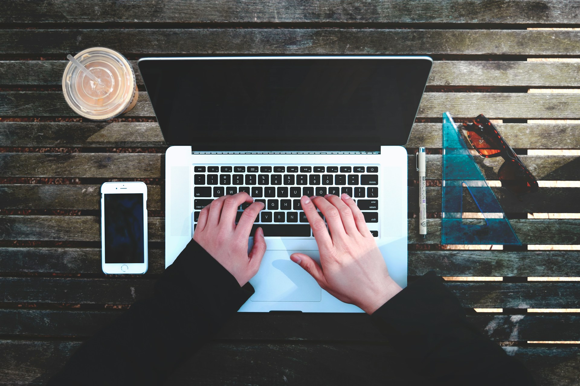 hands typing on a laptop keyboard