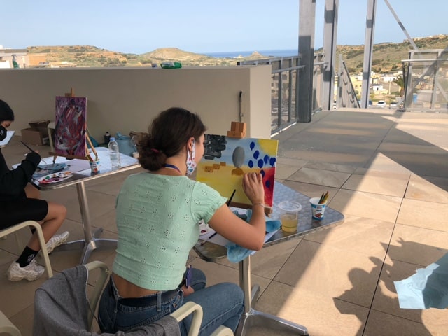 A woman painting as part of a Mindful Art session