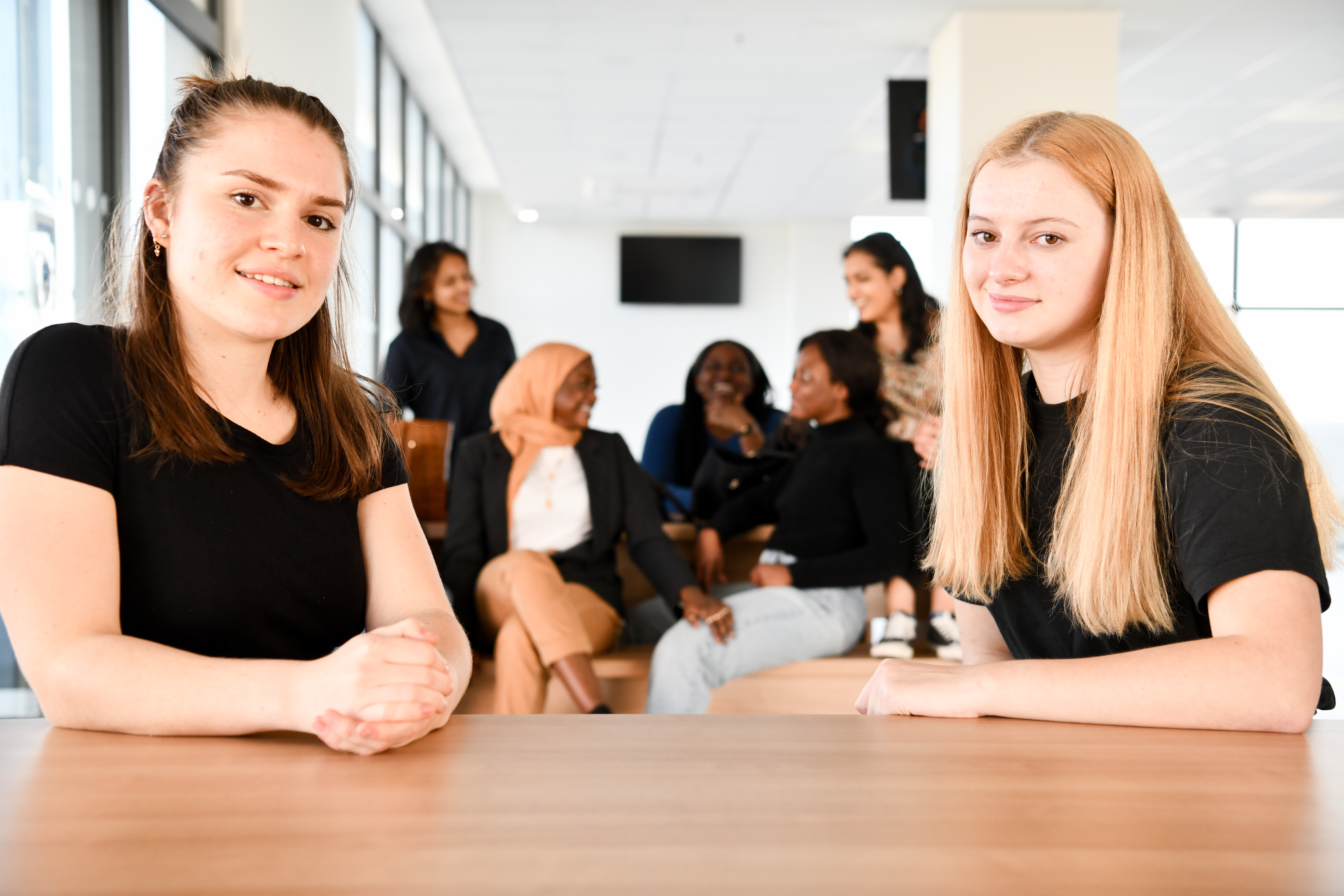 students sitting down looking at camera