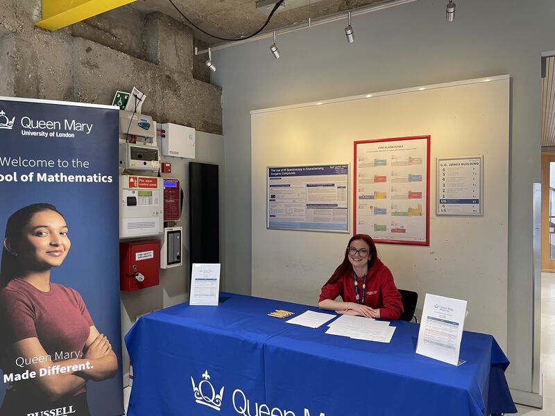 An image of staff member welcoming school students to Girls in Maths Taster Day in 2026 at Queen Mary University