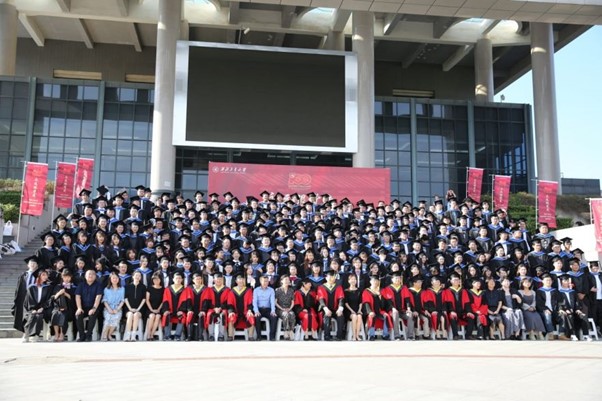 Students pictured sitting formally at graduation