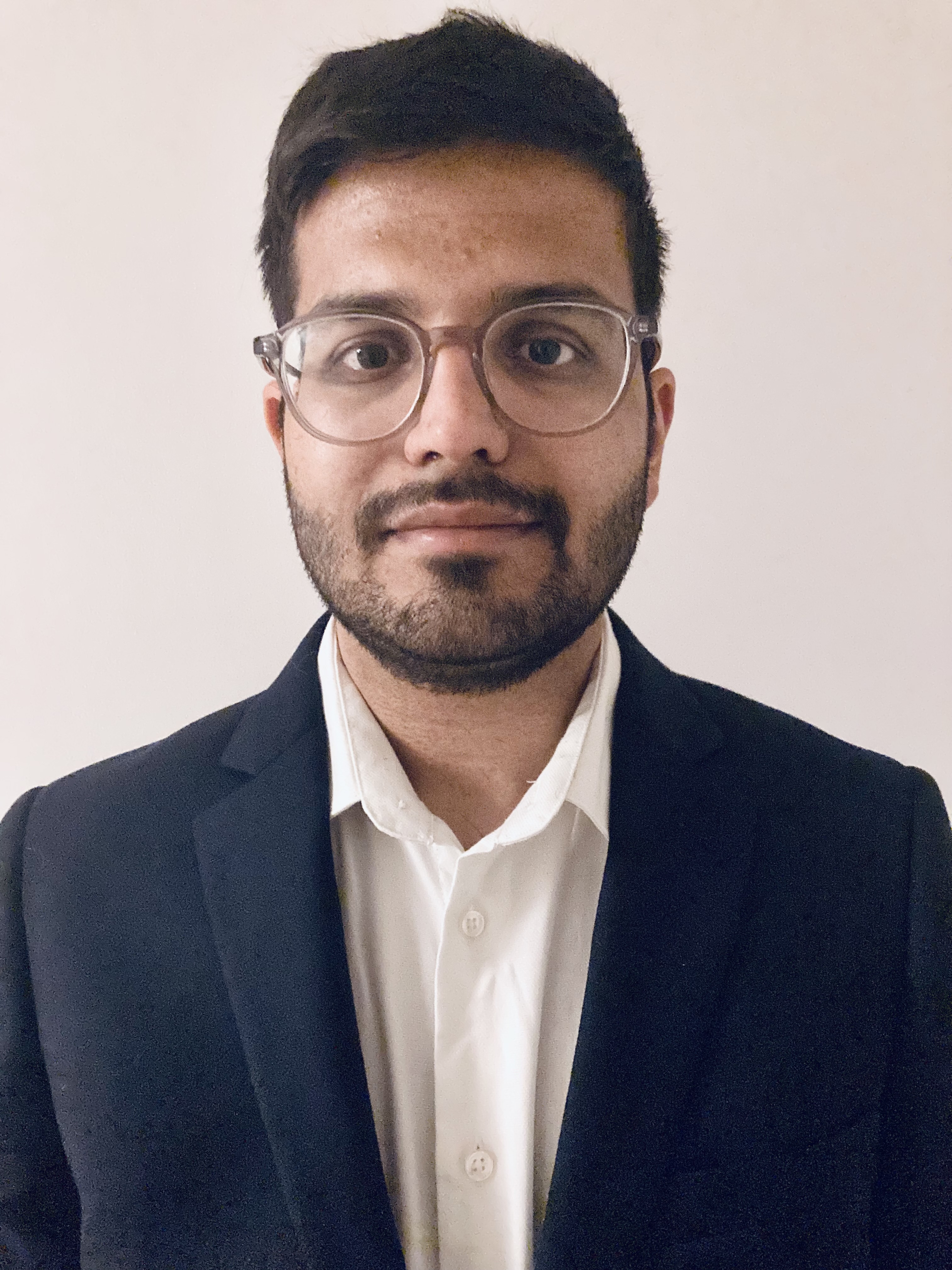 Dr Kshitij Sabnis wearing a white shirt and navy blazer