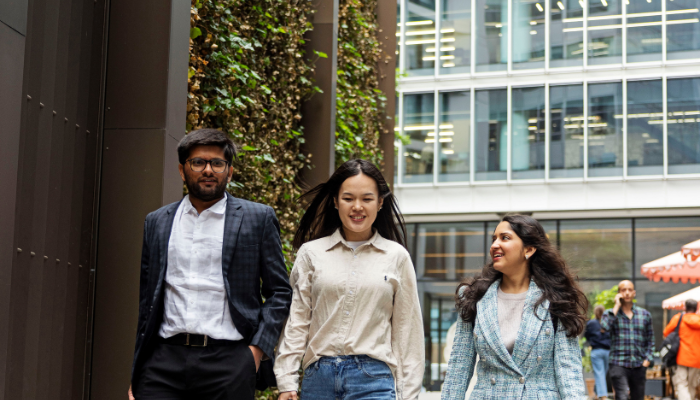 A group of 3 students walking in London