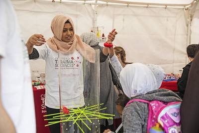 A female volunteer from Centre for Trauma Sciences chats to children at the Festival of Communities